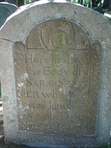 A worn gravestone reading 'Here lies Interr the Body of Ms SARAH SPOONER who deceased January 25th AD 1767.'